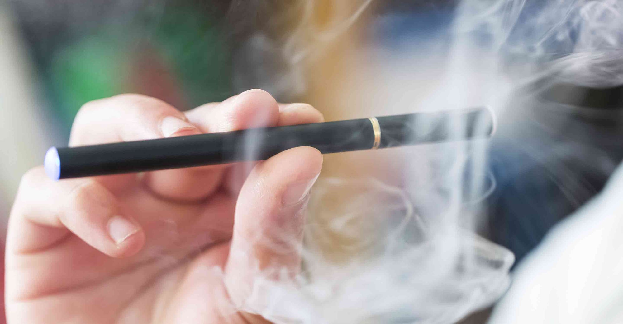 Person taking a puff out of an e-cigarette