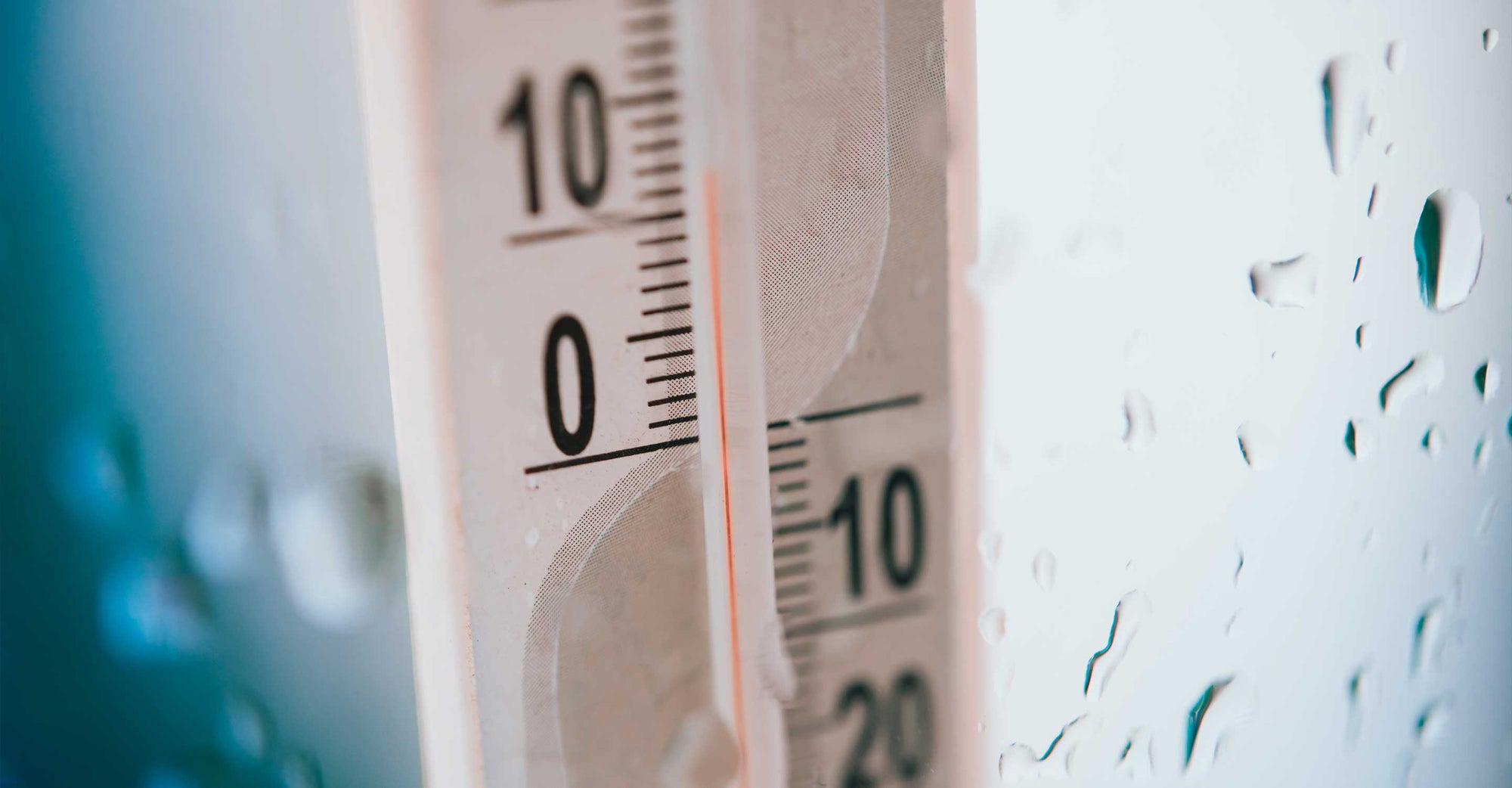 Thermometer on wet window showing high humidity