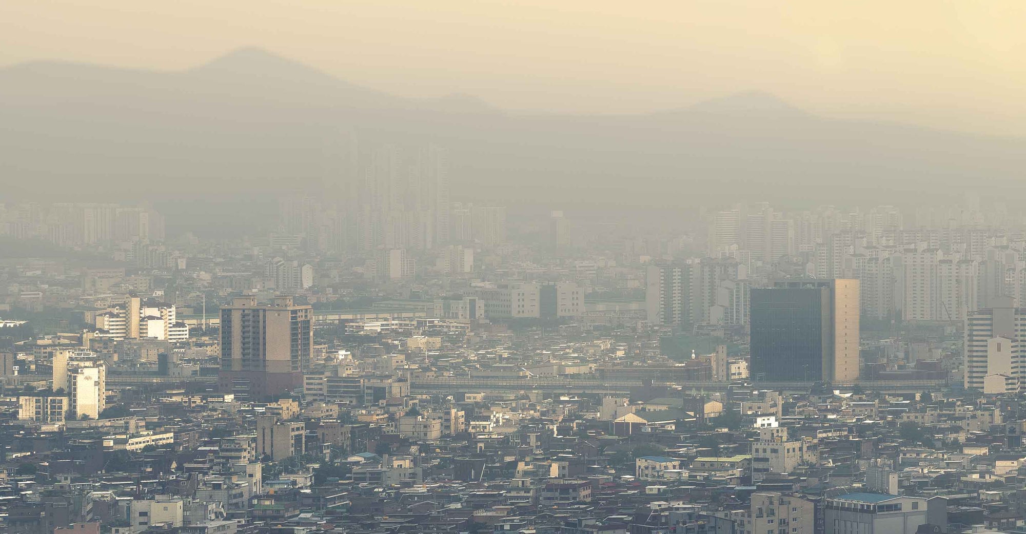 An image of a city skyline with visible smog obscuring anything beyond a couple of miles&#039; visibility.