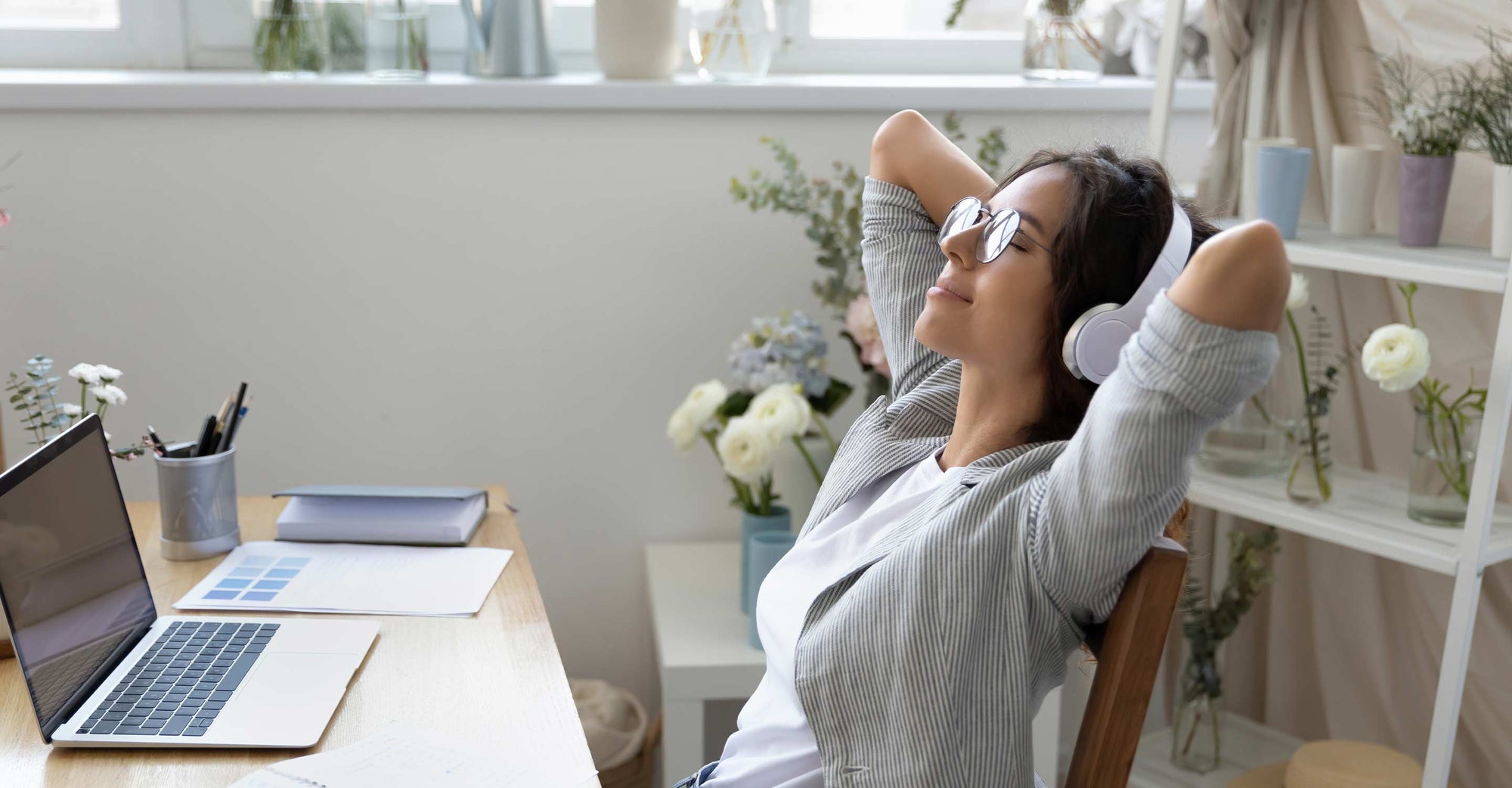 women with headphones siting in chair