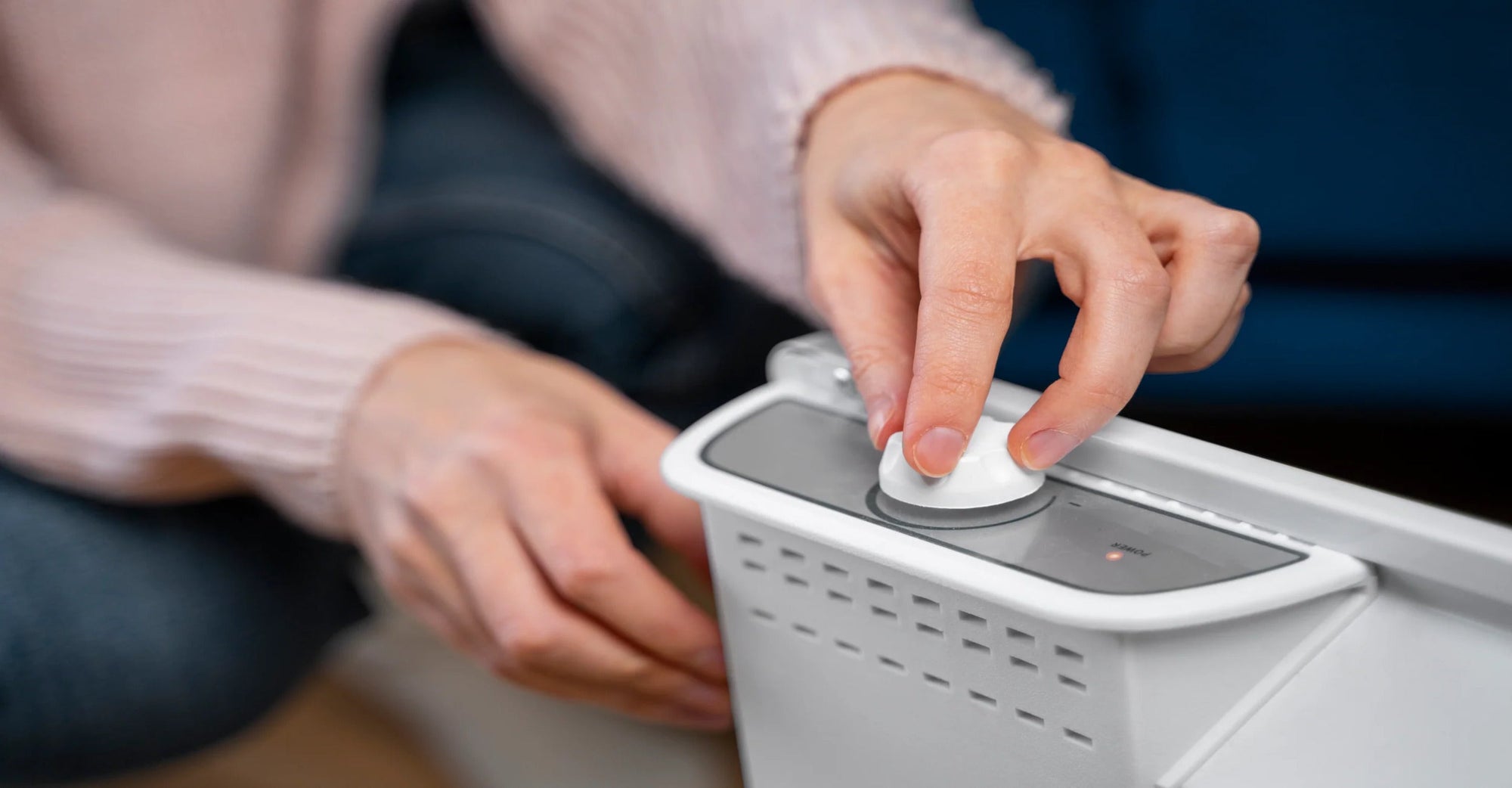 woman turning on the air purifier.