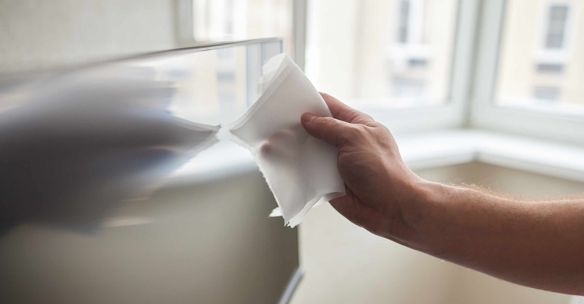 man removing dust from tv