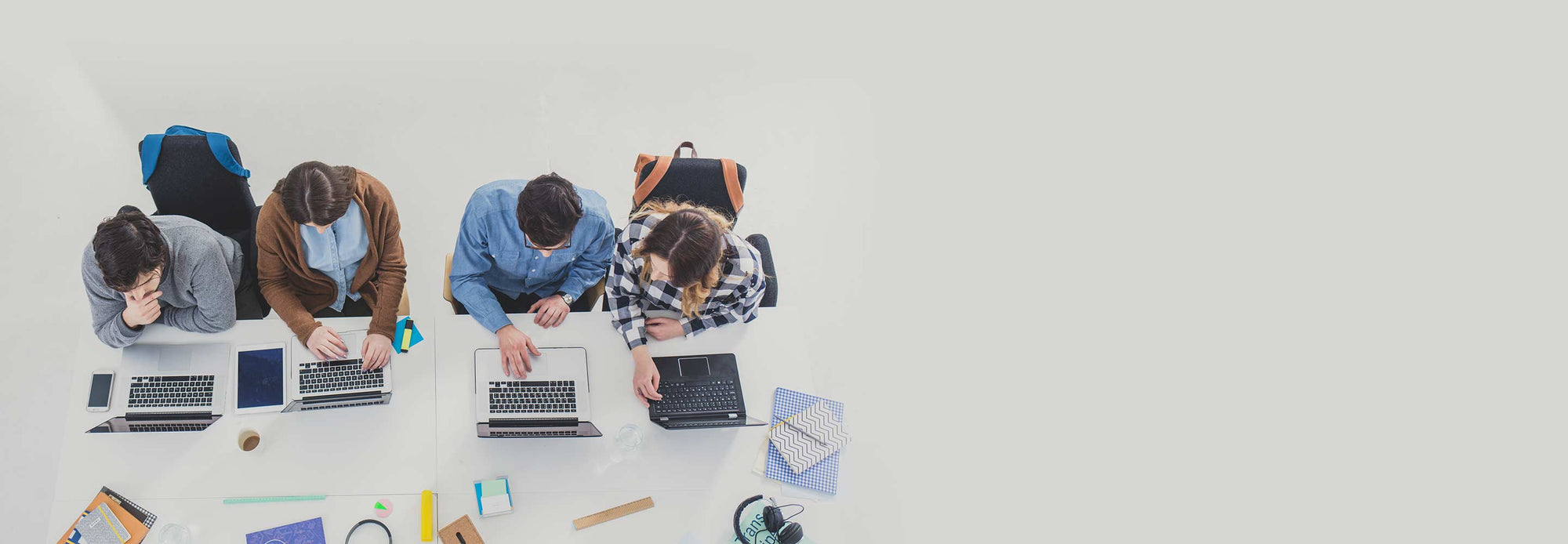 college students overhead working on laptops