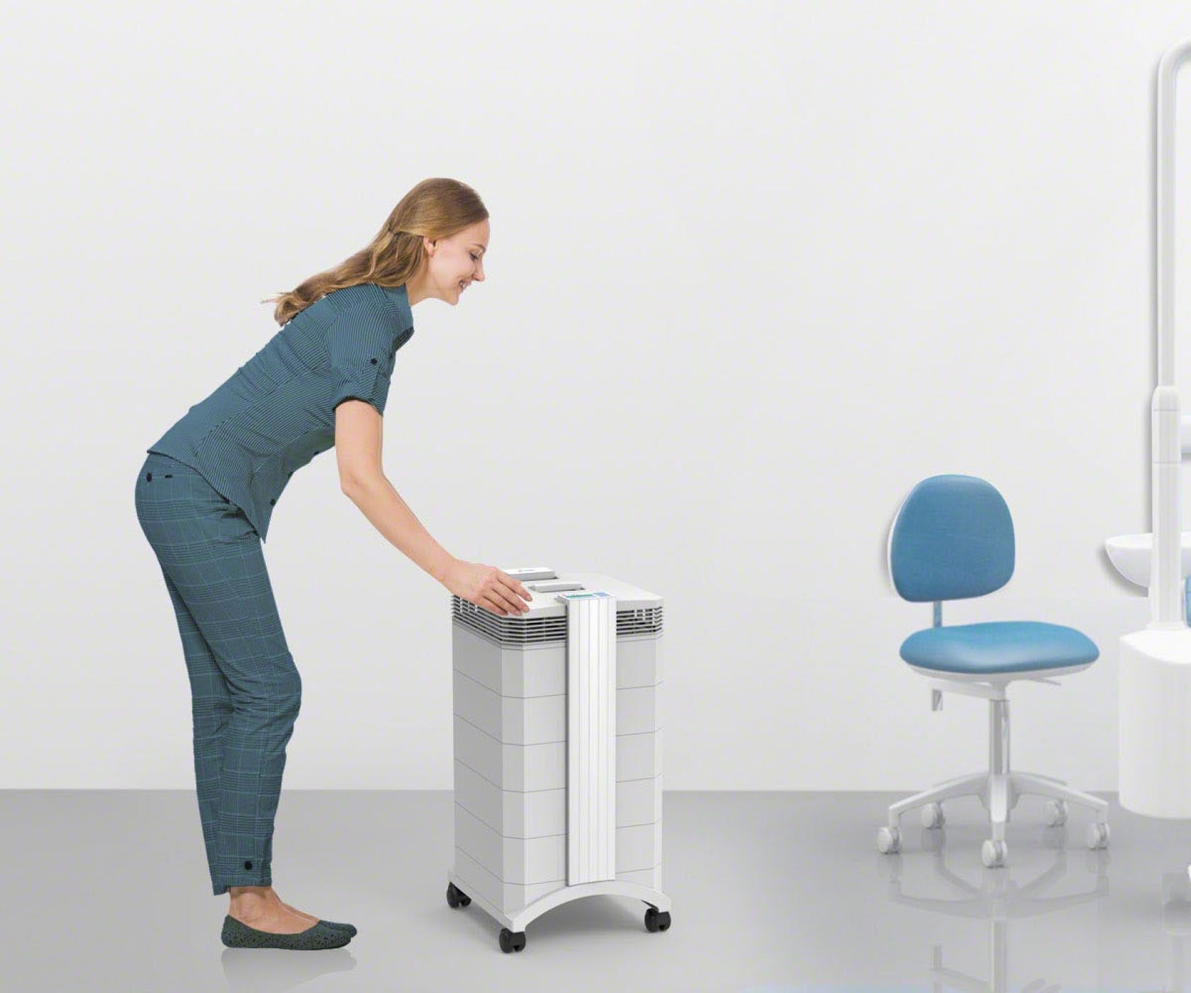 woman turning on Dental Pro in office